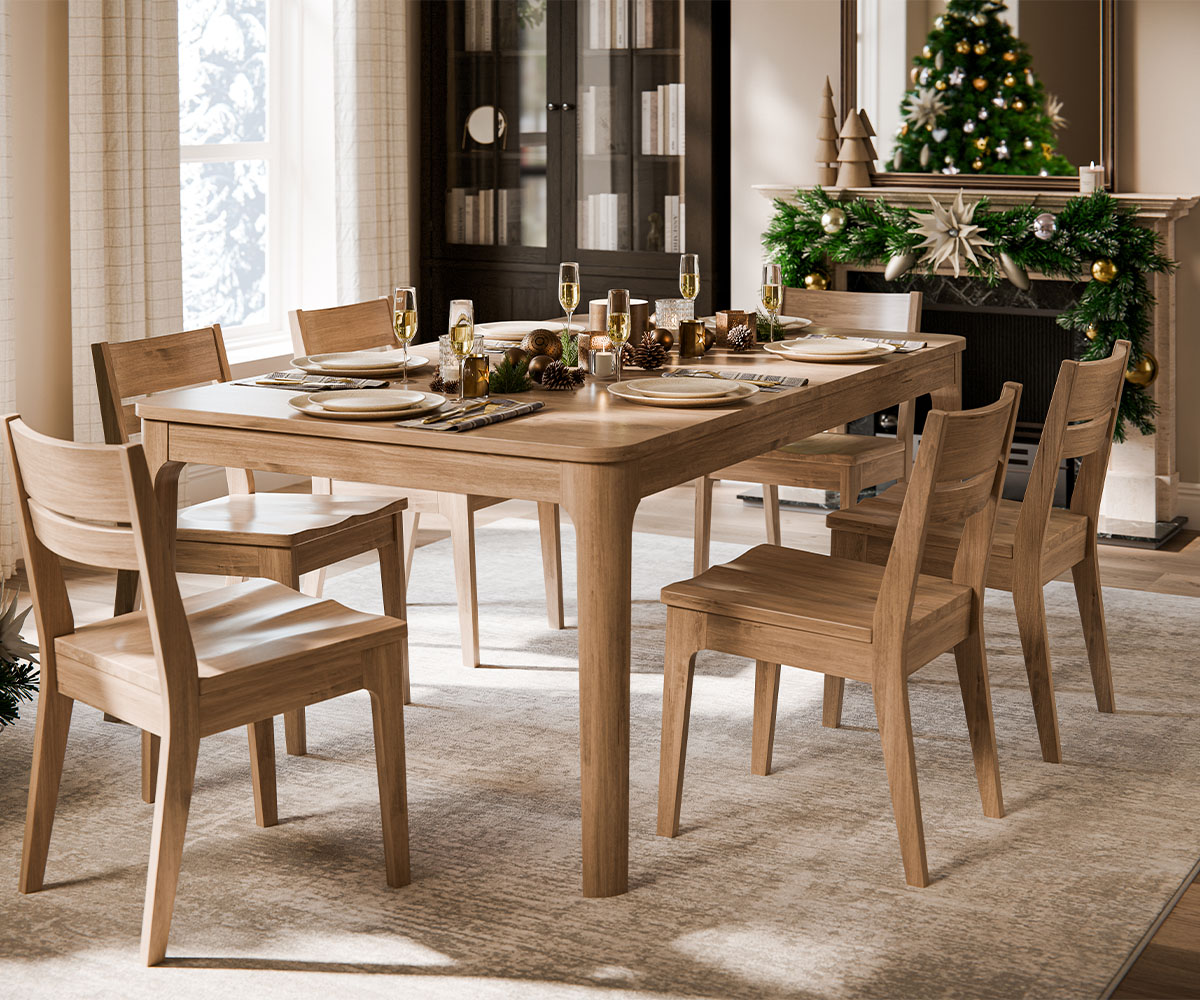 Custom furniture dining set styled for Christmas with light wood table, chairs, and holiday décor.