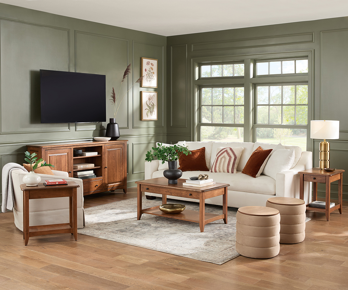 Bright bedroom featuring solid wood furniture, including a canopy bed, nightstand, chest, and dresser with mirror, all in a light natural finish.
